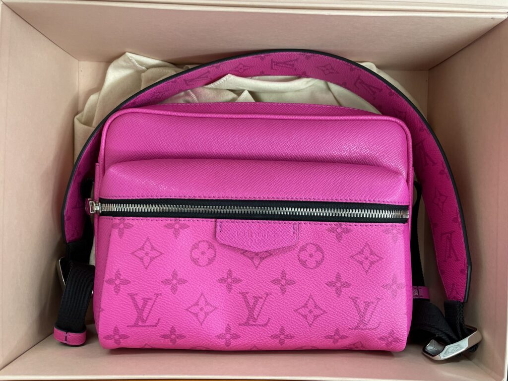 Pink Louis Vuitton monogram leather handbag inside a shipping box.
